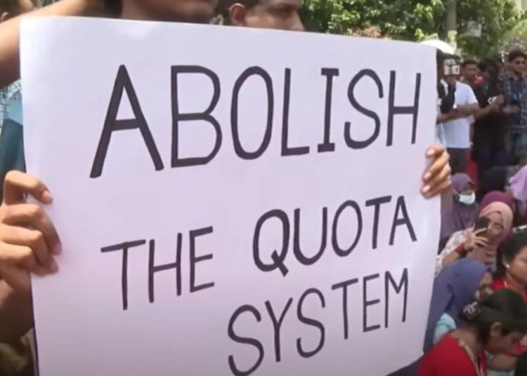 Bangladesh protesters hold a placard that reads: "Abolish the quota system"