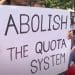 Bangladesh protesters hold a placard that reads: "Abolish the quota system"