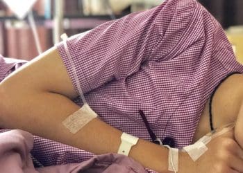 South Asian woman in bed with ME/CFS
