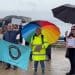 Protesters stand in the rain at Portland port with placards that read: "no floating prison" and "asylum process - EU: 6-9 months - UK: 1-3 years - stuck in limbo". bibby Stockholm Labour