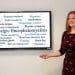 Sally Callow with a screen describing ME/CFS symptoms