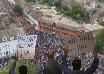 Crowds of antifascists in Walthamstow. Protesters holding up placards that read: "Migrants welcome here" and "Choose peace not hate" race riots