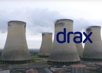 Drax power station pouring out pollution, with the Drax logo.