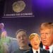 Liz Truss with the lettuce banner unfurling behind her saying "I crashed the economy". An orange Trump, Richard Madeley, and Elon Musk in front.