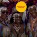 Three Black women at the Notting Hill Carnival, and the event's logo.