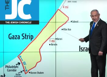 Netanyahu at a press conference with a screen behind him showing a map of Gaza, the Philadelphi Corridor, the Rafah Crossing, Israel, and Egypt. The Jewish Chronicle logo fake