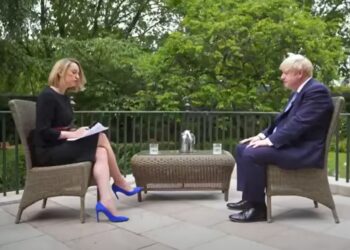 Laura Kuenssberg sat on a garden terrace interviewing Boris Johnson.