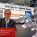 Keir Starmer in front of an International Investment Summit 2024 podium. Stansted Airport behind. A plane taking off, with multiple pound notes falling beneath it Stansted airport expansion Labour climate