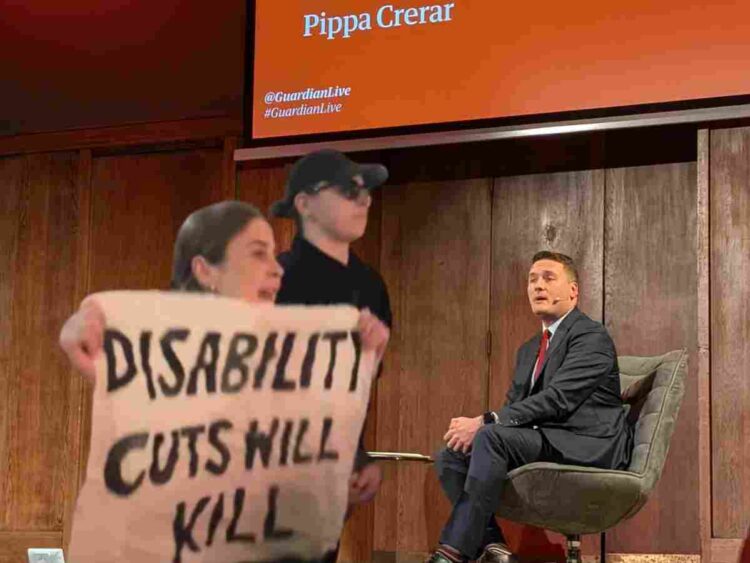 Wes Streeting faced protests over both DWP PIP cuts and NHs privatisation at a Guardian Live event at Conway Hall