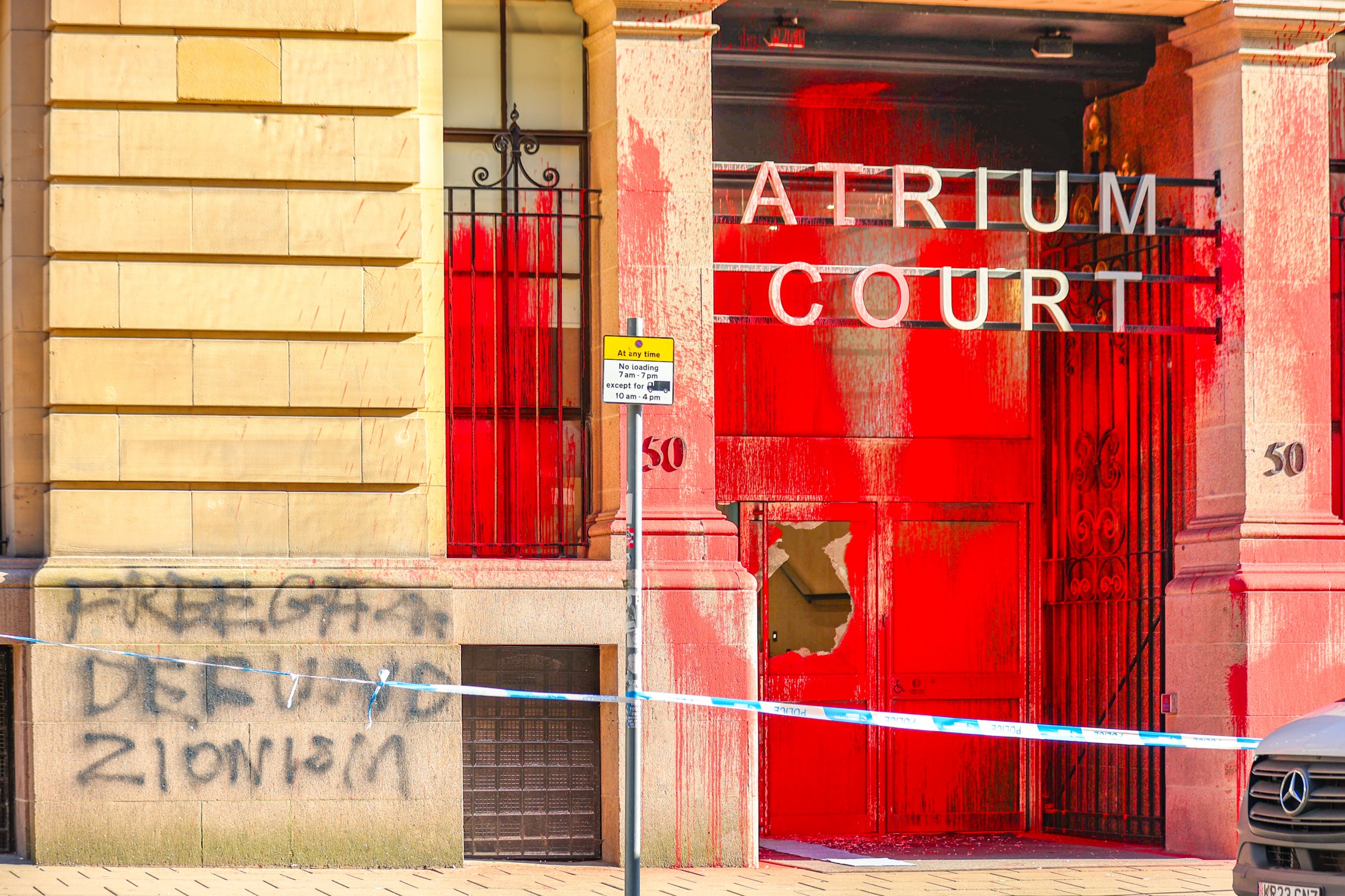 Spray-painted message on the entrance to Atrium Court reads "Free Gaza: defund Zionism". 