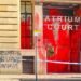 Spray-painted message on the entrance to Atrium Court reads "Free Gaza: defund Zionism". Red paint all over the front entrance, with police cordon stretching out in front.