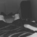 Man's legs raised in bed, with a blanket, and electrolyte sports drinks to his side ME/CFS