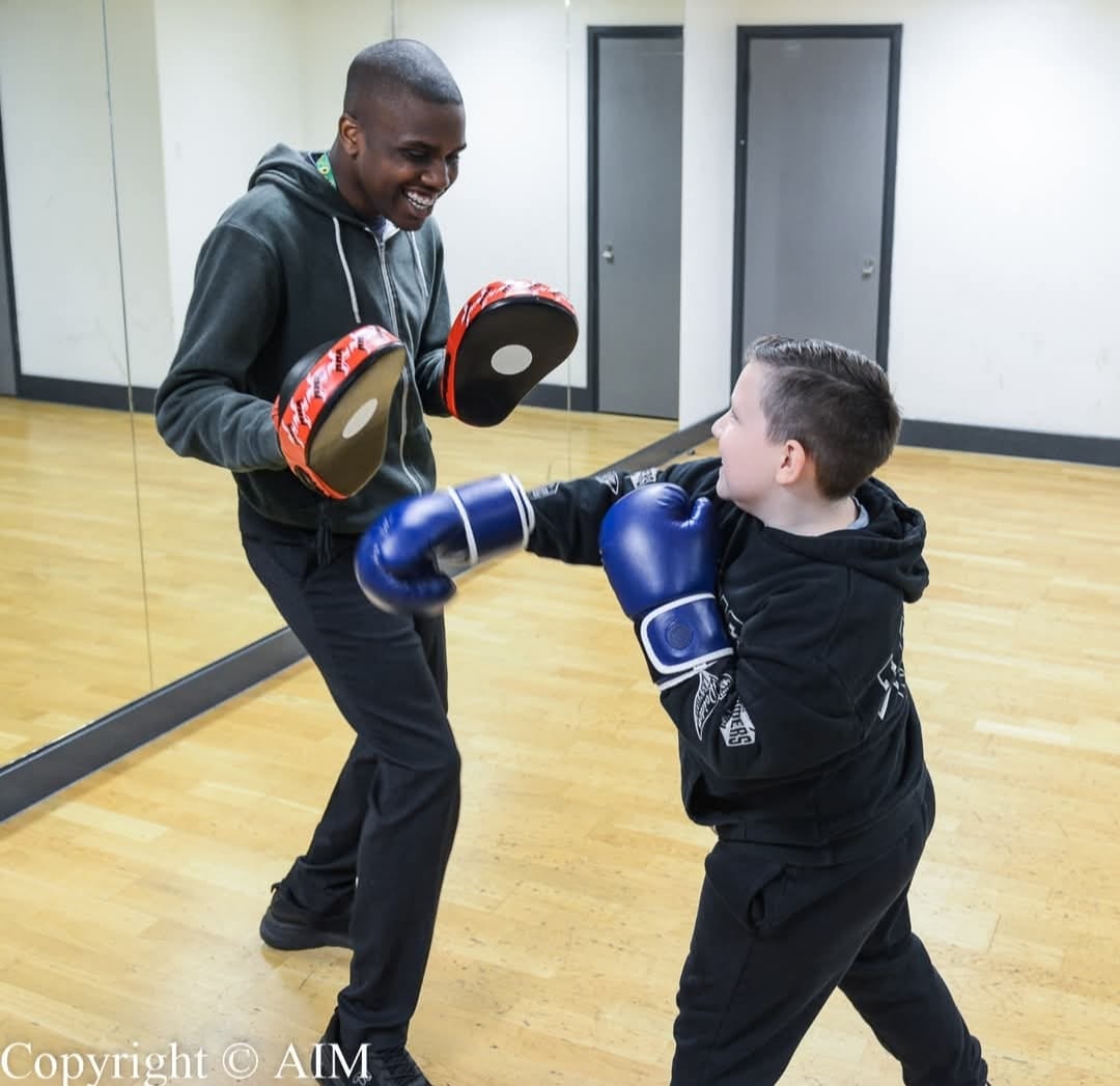 Child and adult boxing.