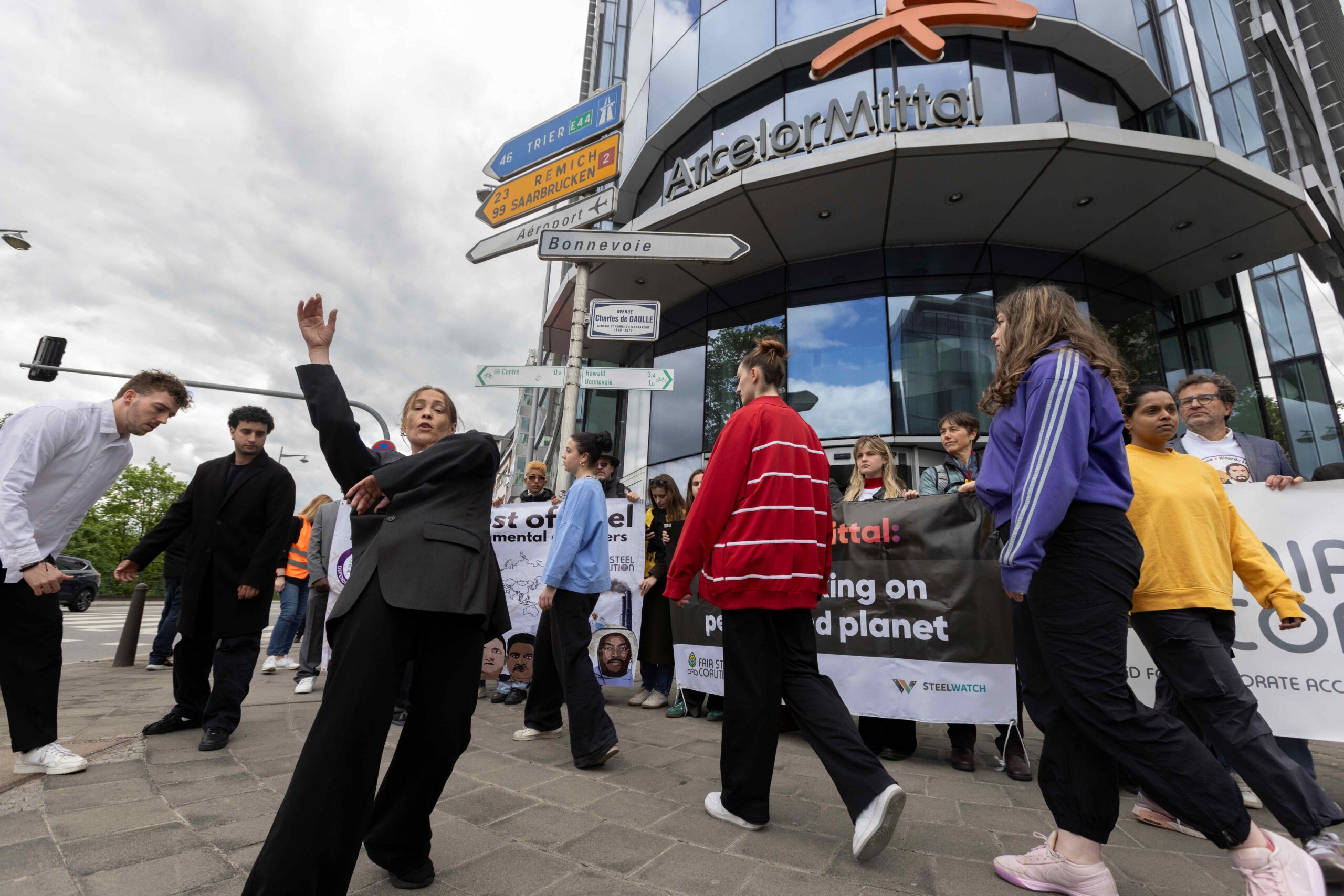 Protesters dance in front of ArcelorMittal's HQ.