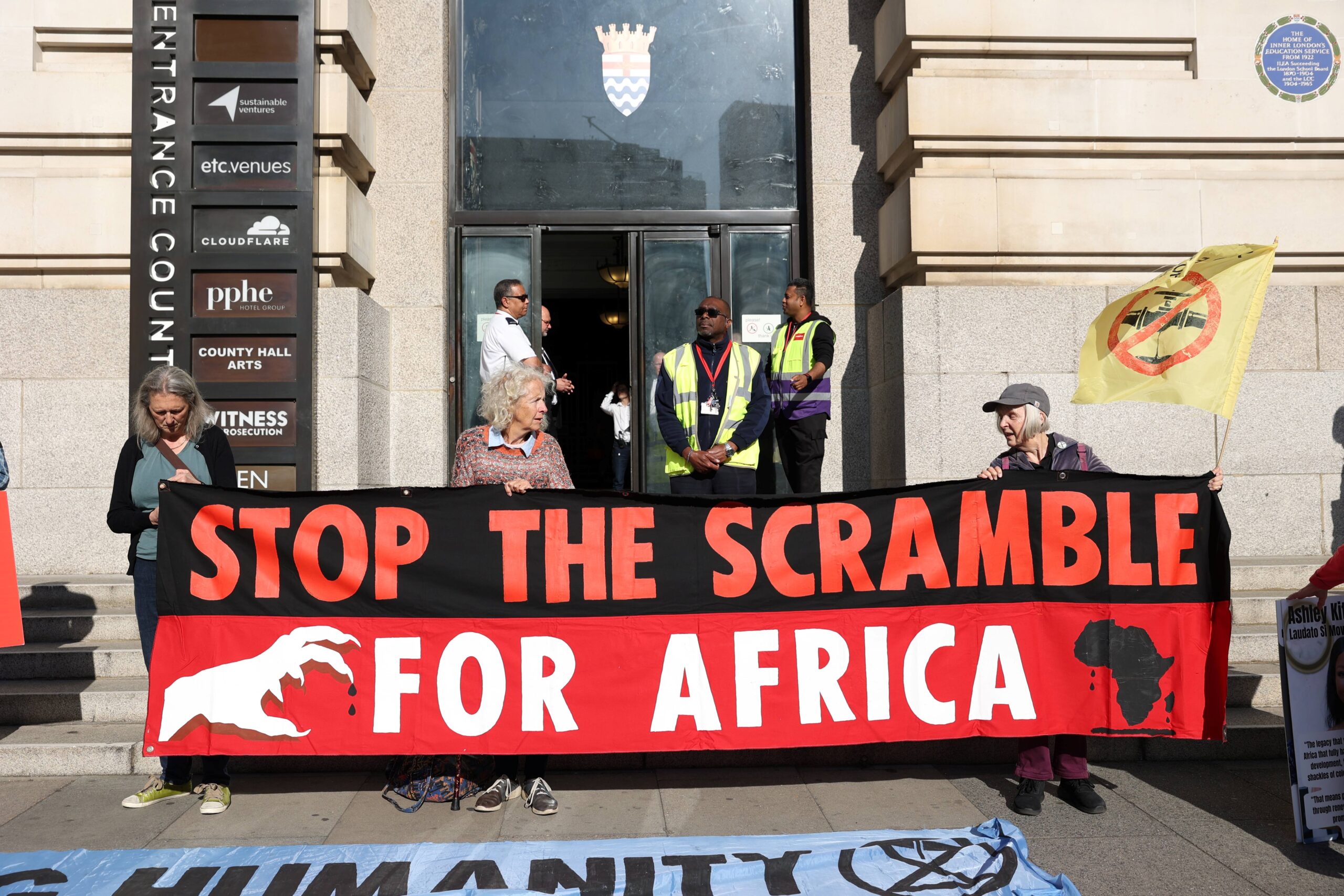 Activists gather outside Africa Energy Summit with banners reading: "Stop the scramble for Africa". 