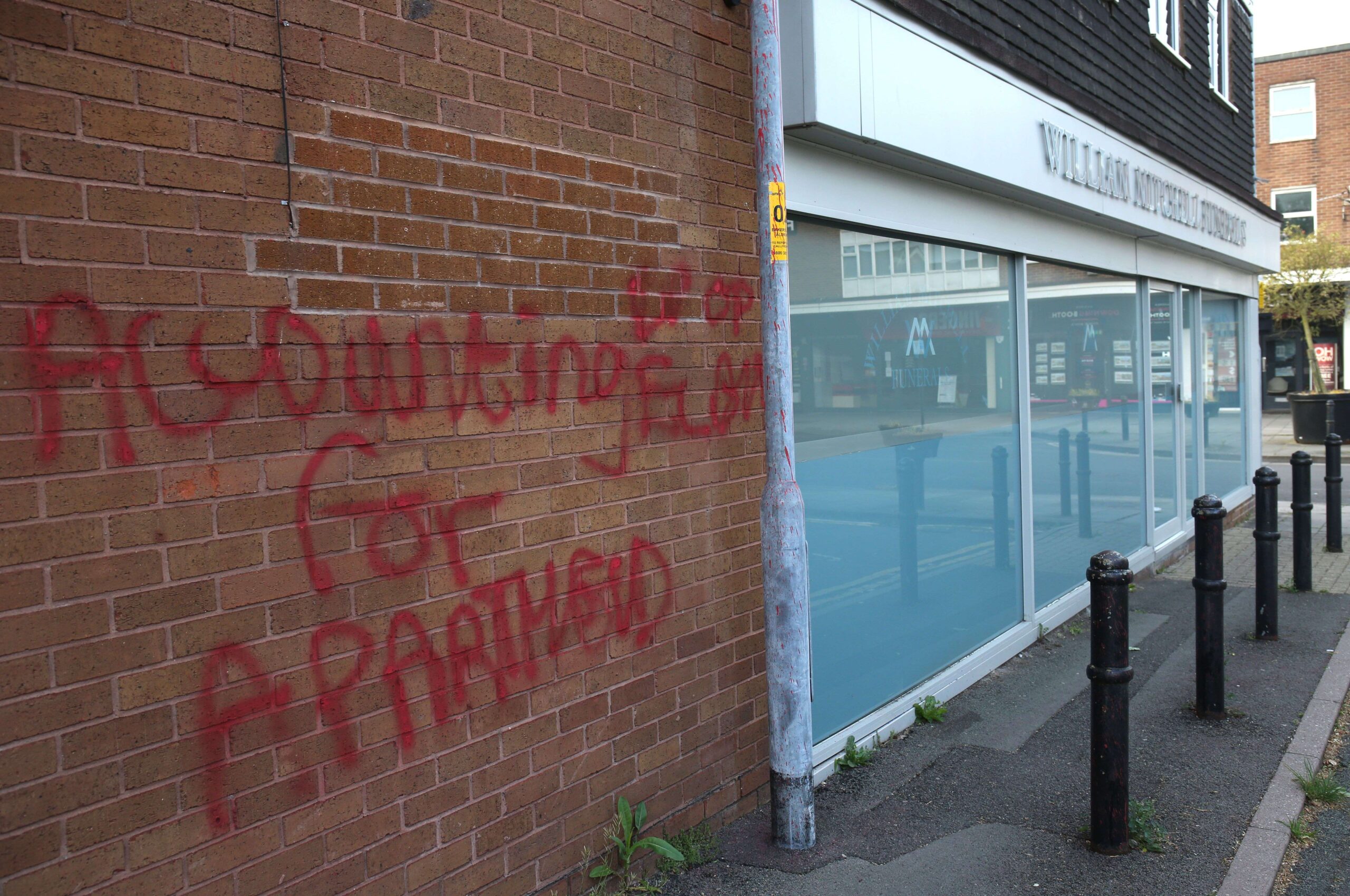 Red graffiti reading: "Accounting for Apartheid"