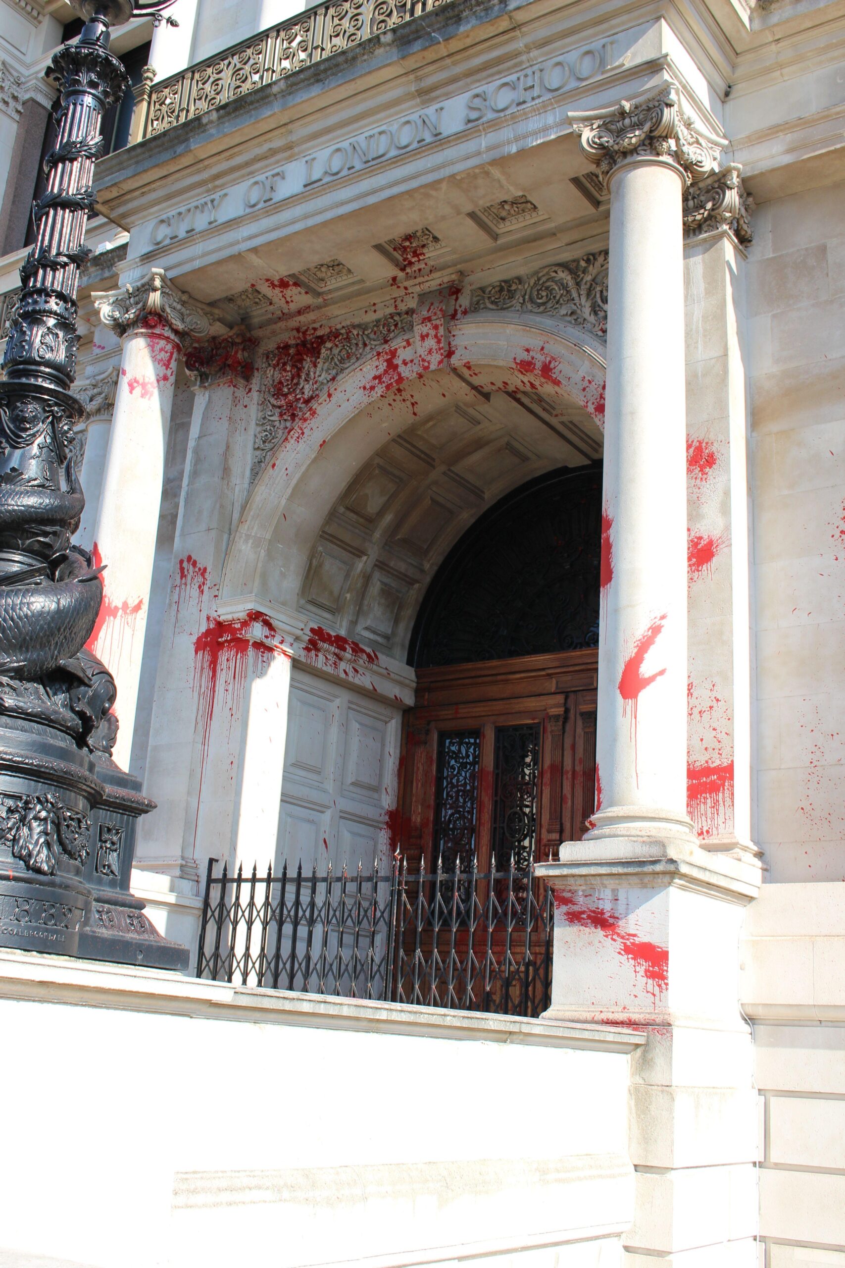Pillars and entrance to JP Morgan spattered with red paint.