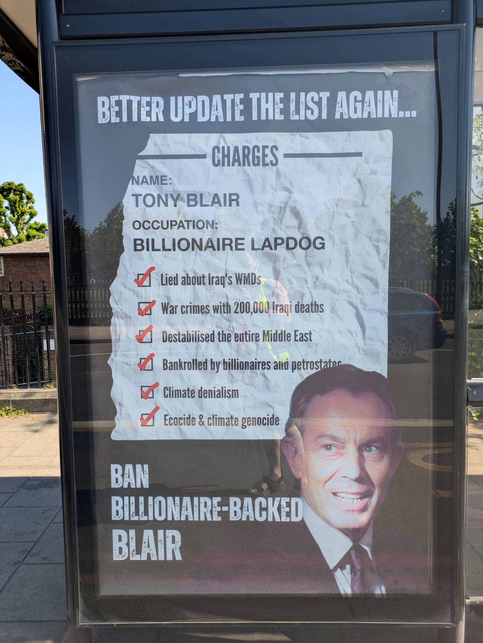 Advert reads: BETTER UPDATE THE LIST AGAIN .. CHARGES NAME: TONY BLAIR OCCUPATION: BILLIONAIRE LAPDOG Lied about Iraq's WMDs War crimes with 200,000 Iraqi deaths Destabilised the entire Middle East Bankrolled by billionaires and petrostates Climate denialism Ecocide & climate genocide BAN BILLIONAIRE-BACKED BLAIR
