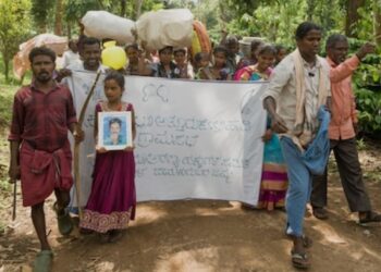 Jenu Kuruba families begin their long-awaited re-occupation of their ancestral homes inside the Nagarhole National Park. They carried photos of loved ones who had died after the village was evicted, so they too can return to the forest.