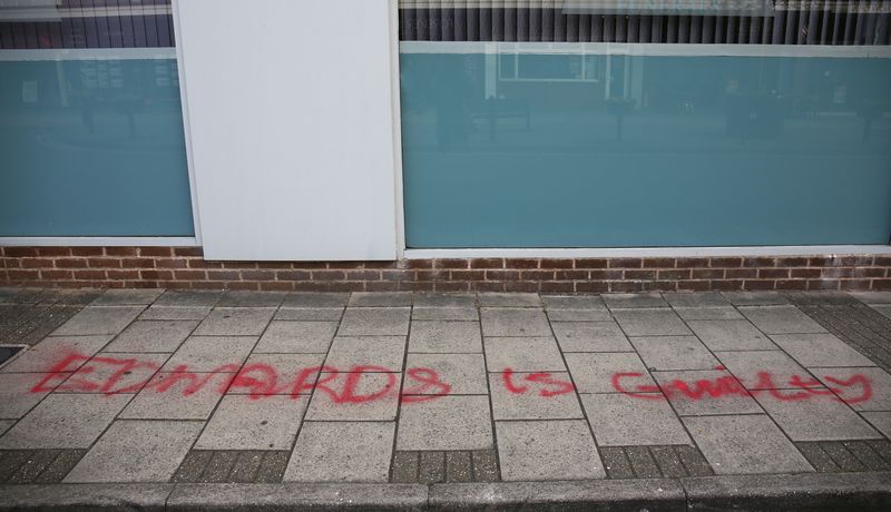 Red graffiti on the floor that reads: "Edwards is guilty"