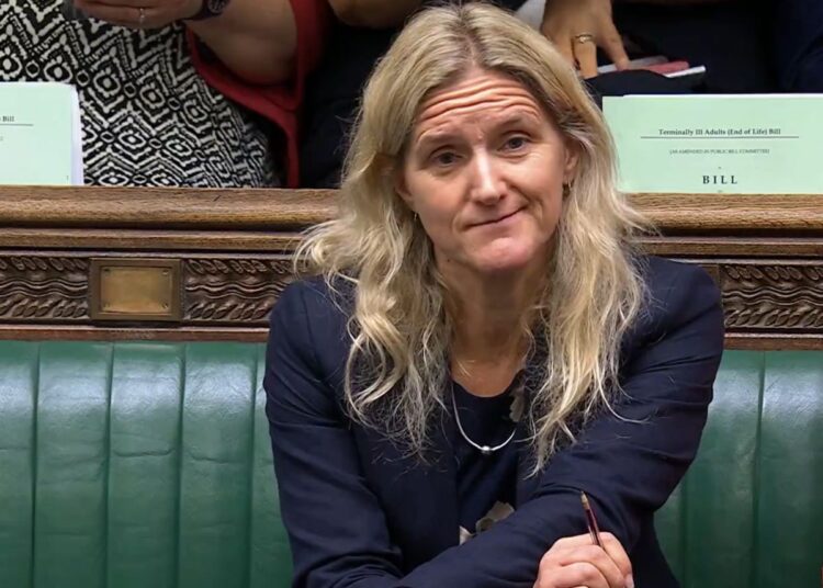 Kim Leadbeater shaking her head on the benches in the House of Commons during a debate on the assisted suicide bill.