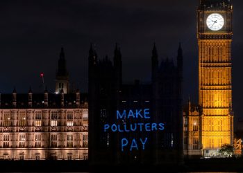 'Make polluters pay' projected onto the Houses of Parliament Make Them Pay