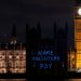 'Make polluters pay' projected onto the Houses of Parliament Make Them Pay