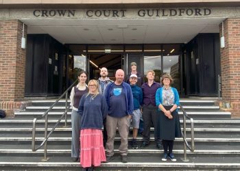 Group of Just Stop Oil activists standing trial stood outside 'Crown Court Guildford'.
