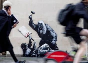 Banksy illustration of a judge beating up a protester with his gavel