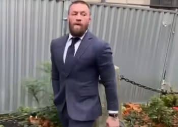 Conor McGregor in a suit walking out of court after previous case he lost.