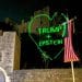 Green heart projection on Windsor Castle reads: "Trump + Epstein"