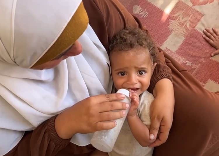 Palestinian mother feeding her crying baby milk from a bottle Gaza unborn children