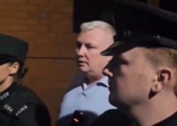 Two PSNI police in front of the BBC's Stephen Nolan.
