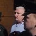 Two PSNI police in front of the BBC's Stephen Nolan.