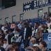 Samaritans and Bright & Hove Albion video. Football fans in the stands, with two men walking to their seats.