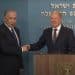 Netanyahu and German chancellor Scholz shake hands at a press conference.