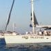 Global Sumud Flotilla vessels sail towards Gaza with 'Free Palestine' on the hull, and Palestine flags.