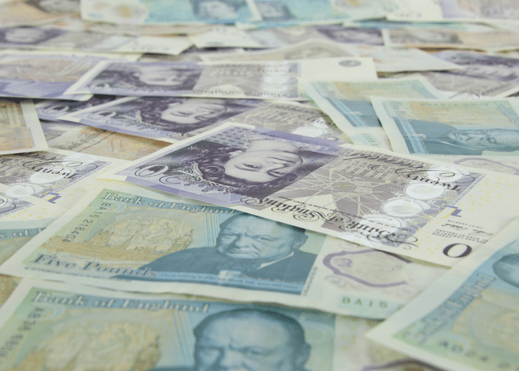 British bank notes laid flat. Sunday Times Rich List features 350 wealthy families or individuals resident in the UK