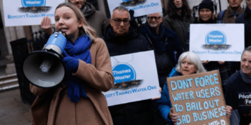 Thames Water protestors outside with megaphones and one placard that reads: 'Don't force water users to bail out bad business. Take water back'.