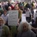Protesters holding placards reading "I oppose genocide. I support Palestine Action" Defend Our Juries