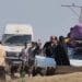Displaced Palestinians in Gaza carry their possessions by hand or piled on vehicles, seeking safety and shelter.