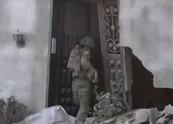 Israeli soldier entering a ruined building in Gaza City UNRWA