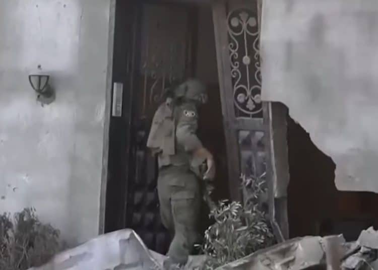 Israeli soldier entering a ruined building in Gaza City UNRWA