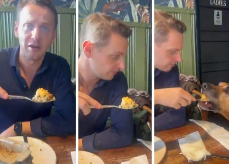 Mike Tapp feeding his dog food with a fork