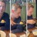 Mike Tapp feeding his dog food with a fork