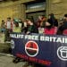 Acorn supporters outside Norwich City Hall, holding a banner saying Bailiff Free Britain Dignity Not Debt