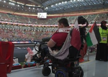 A fan in a wheelchair in the disabled people's viewing area at the Arab Cup