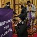 P:rotestors in house of lords hold a banner saying Replace The Lords