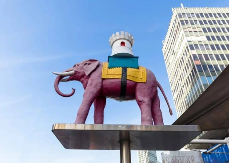 The Elephant and Castle symbol, an elephant with a castle on its back, against a blue sky.