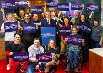 Equity general secretary Paul W Fleming surrounded by Equity members holding placards that say Performers Demand AI Protections In Film And TV